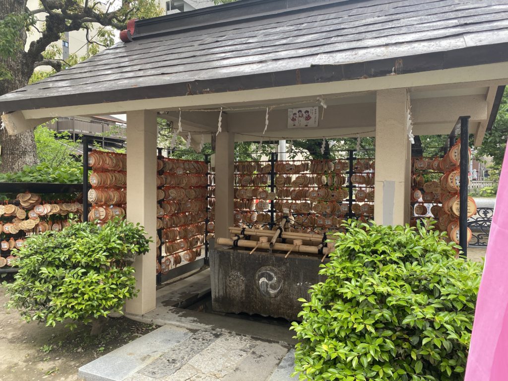 今戸神社の手水舎。ここにも丸い絵馬がたくさんあります