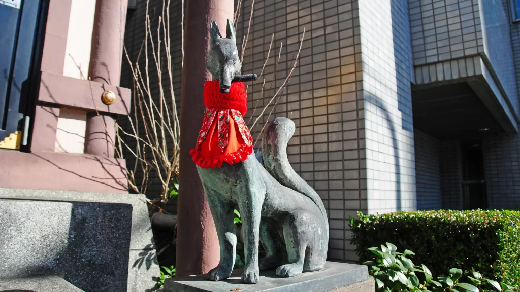 伏見三宝稲荷神社米倉の鍵を加えるお狐様。残念ながら鍵の部分は欠損してしまっているようです。